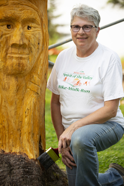 Spruce Carving Anglin Lake 2018   .....Photography by K Davidson - Doris applying stain